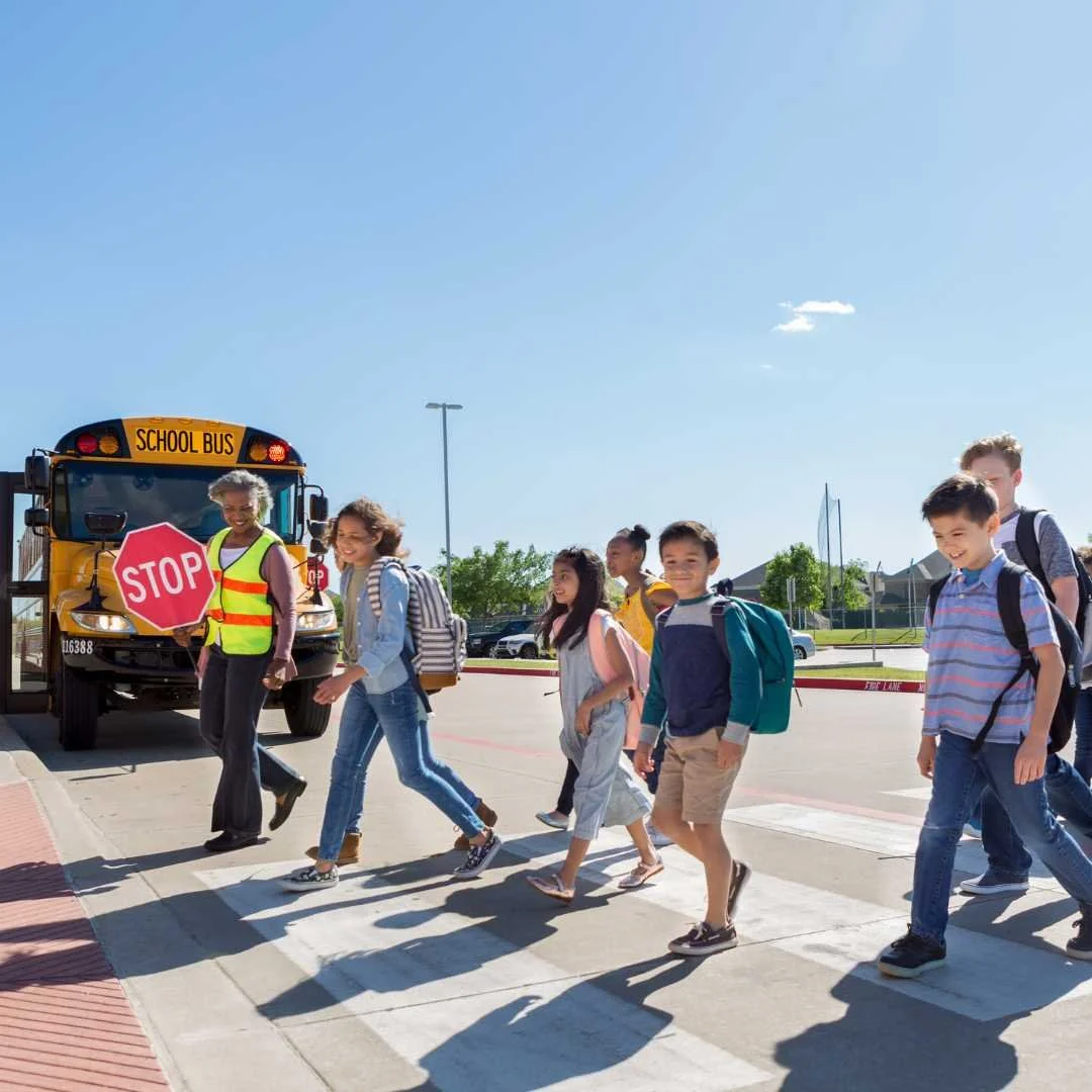 kids walking across crosswalk to school