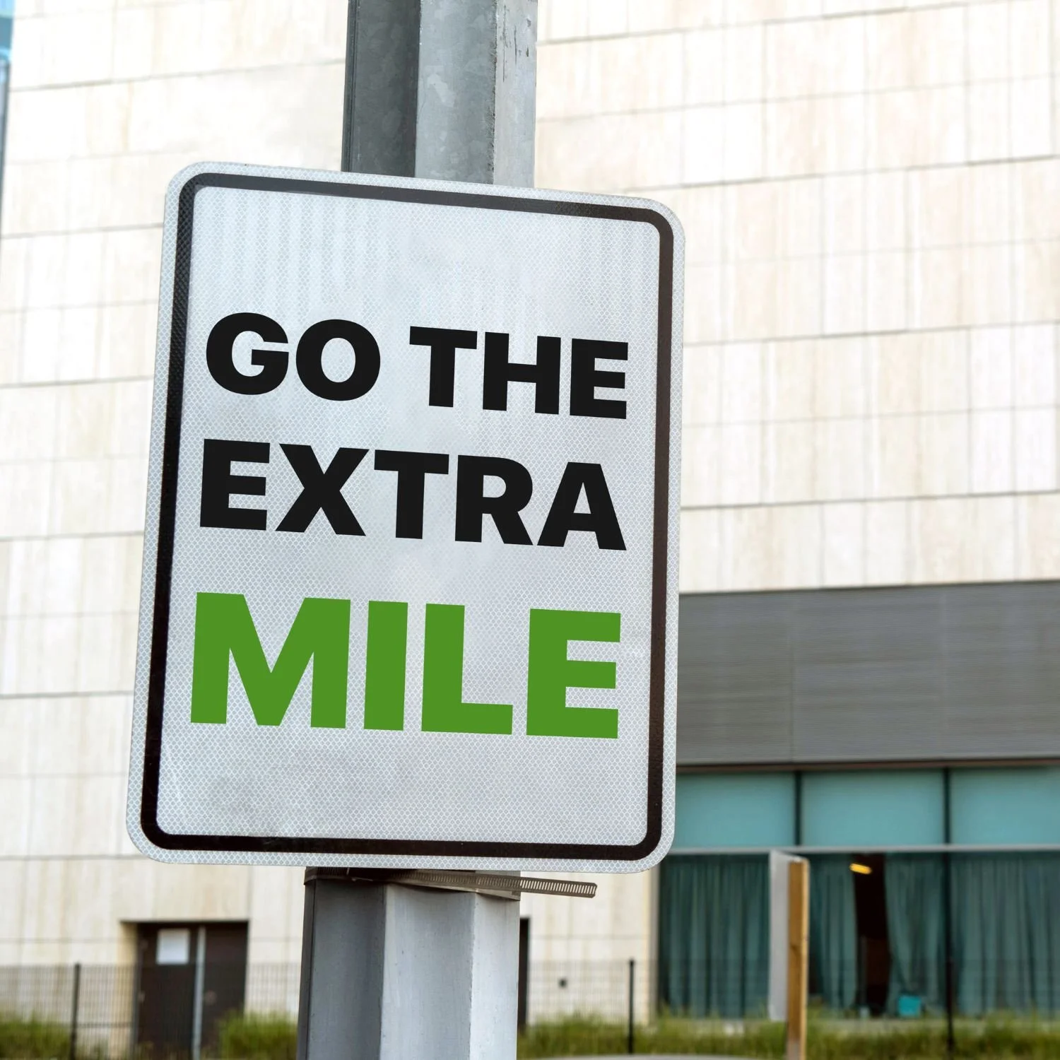 image of a street sign with the phrase "go the extra mile"