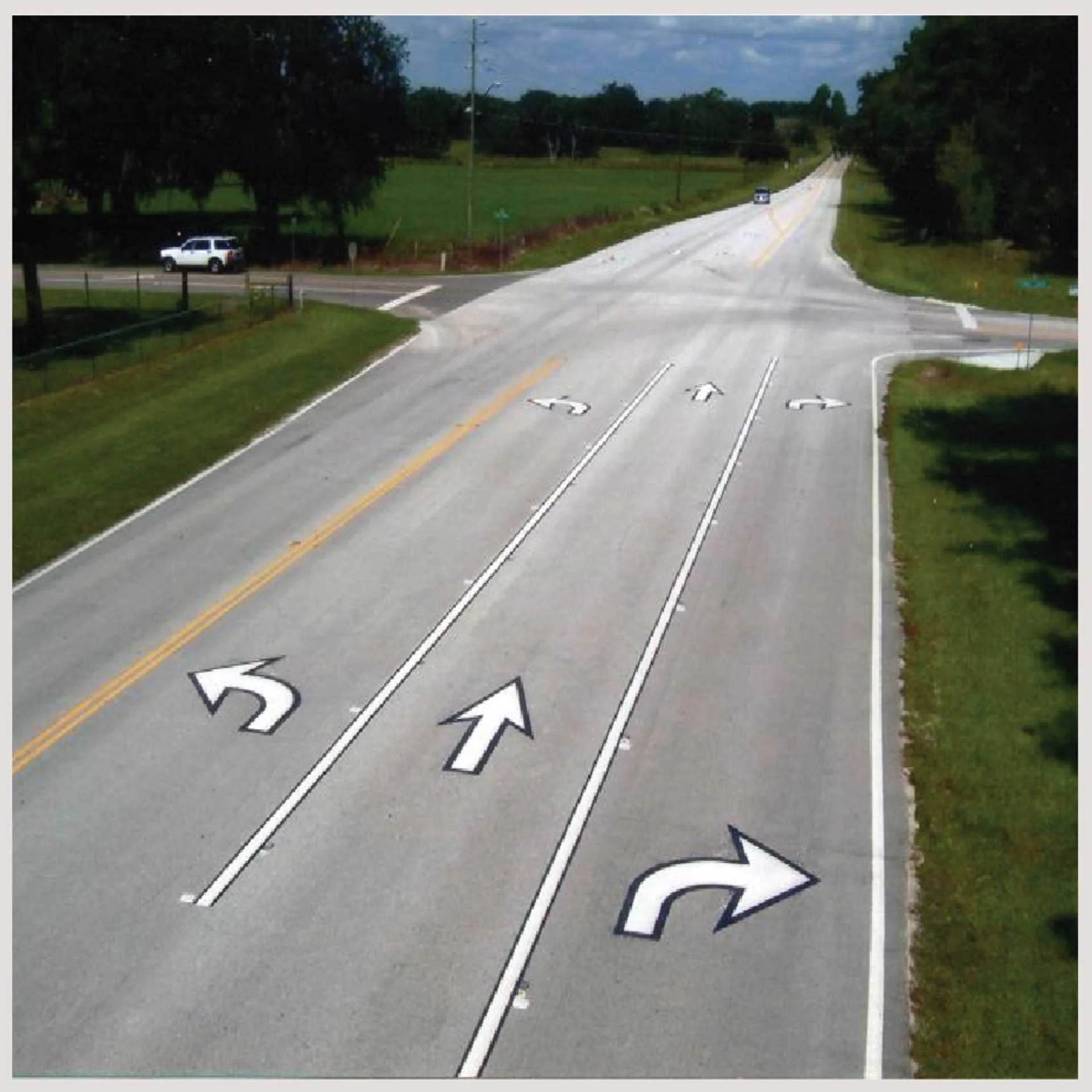A road featuring multiple arrows painted on its surface, guiding traffic in various directions.