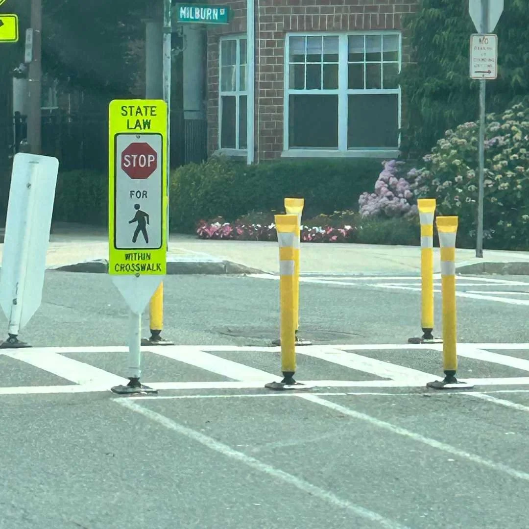 A street scene featuring a crosswalk and a stop sign, indicating pedestrian safety and traffic control.