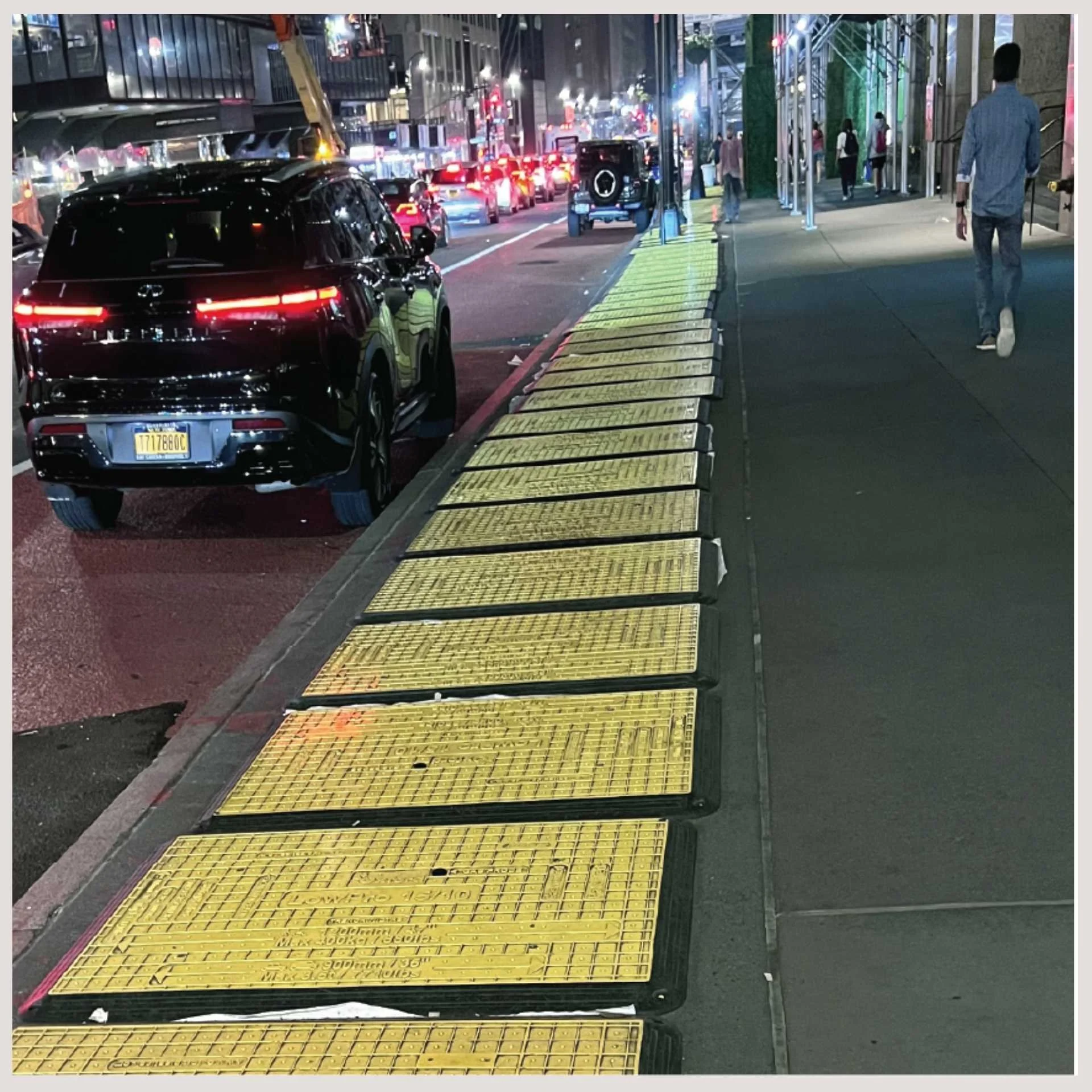 road plates along the road on a busy city street