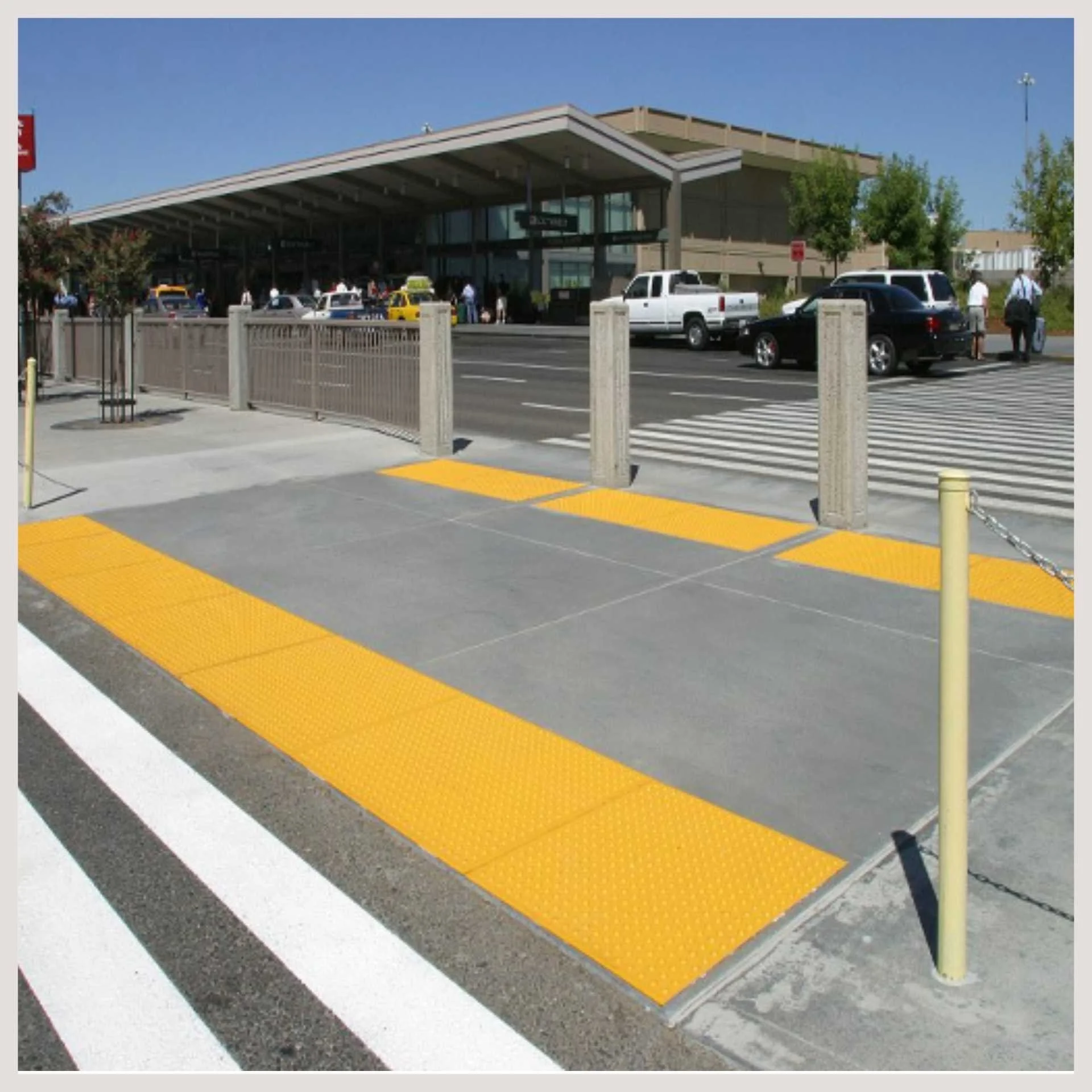 A yellow and white striped pedestrian crossing is prominently displayed, indicating a safe area for pedestrians to cross.