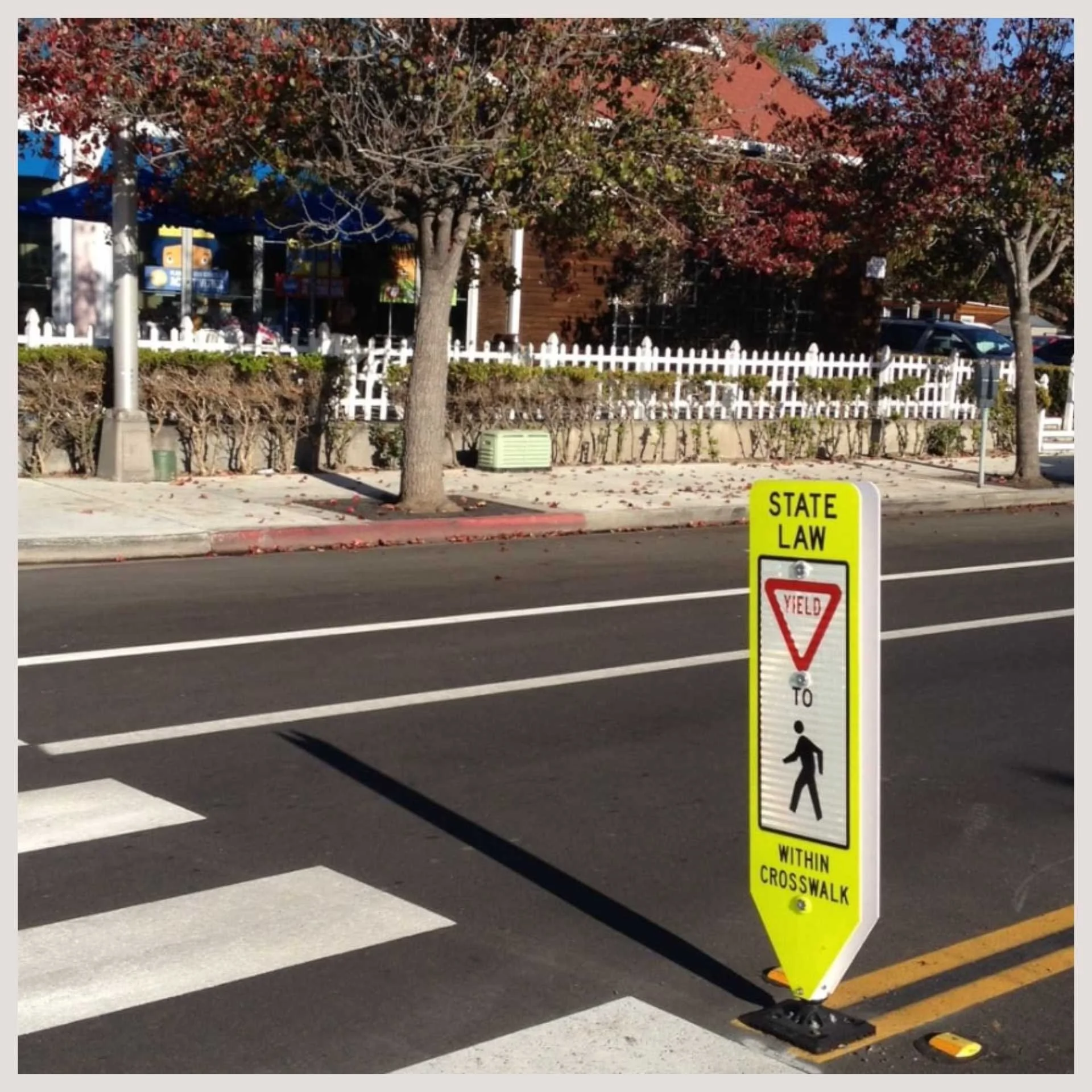 A street sign positioned on the roadside, indicating directions or information for passing vehicles.