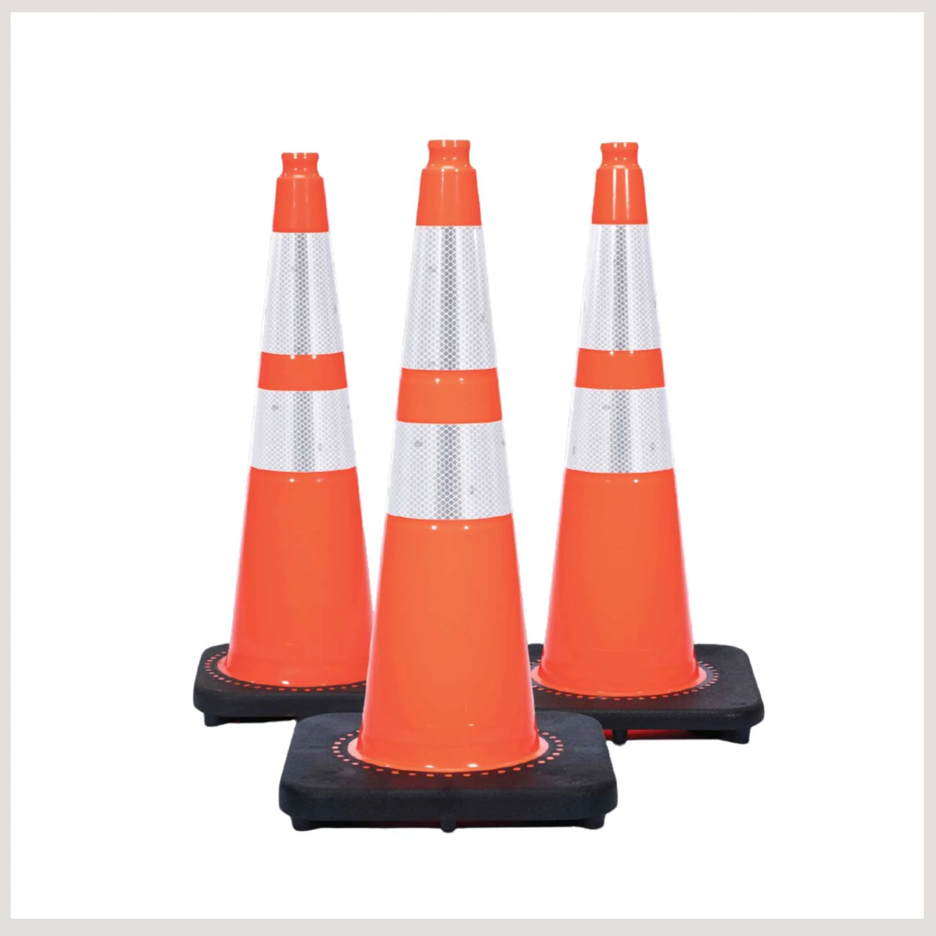 Three orange traffic cones with white bases arranged in a row on a flat surface