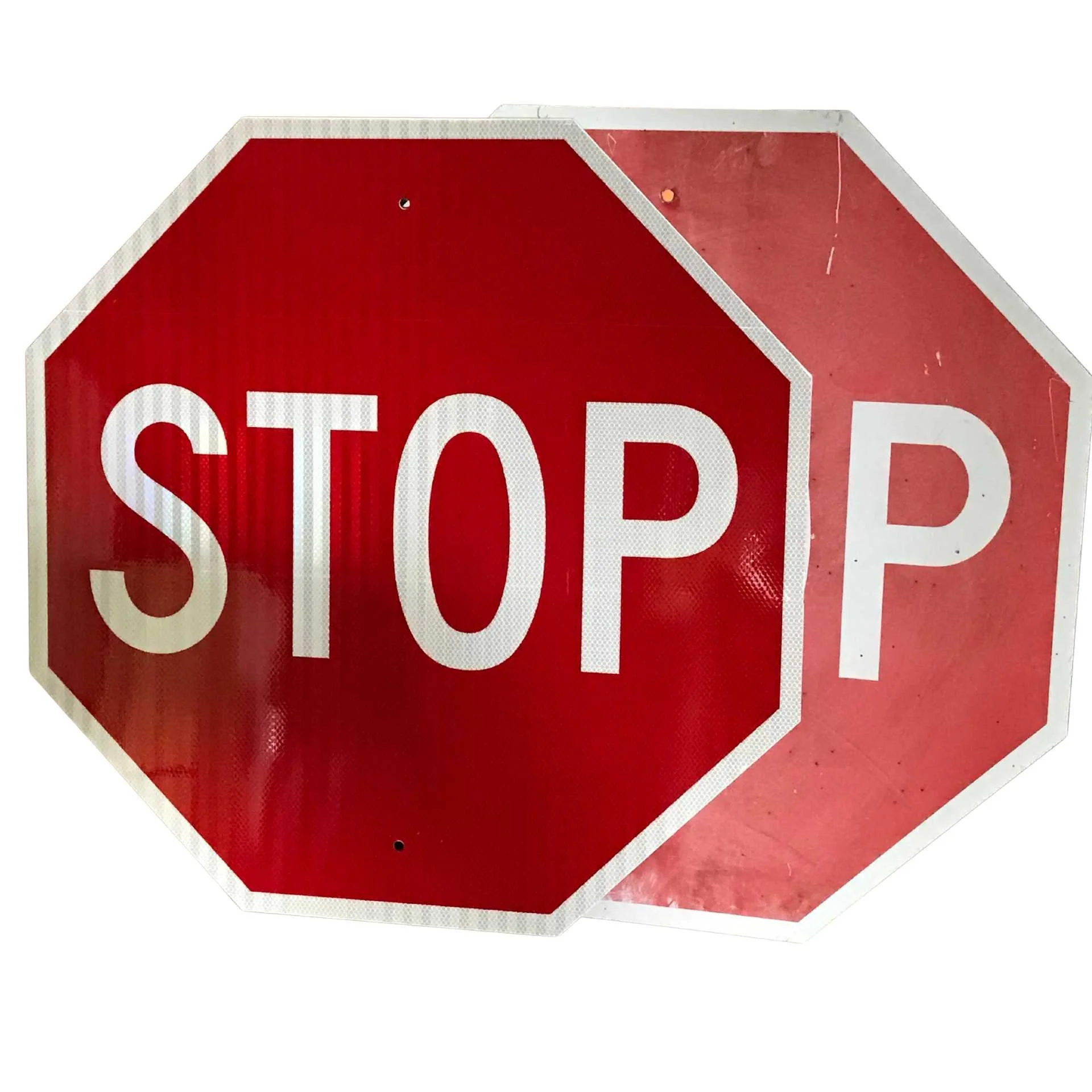 Two stop signs featuring white letters, prominently displayed against a clear background.