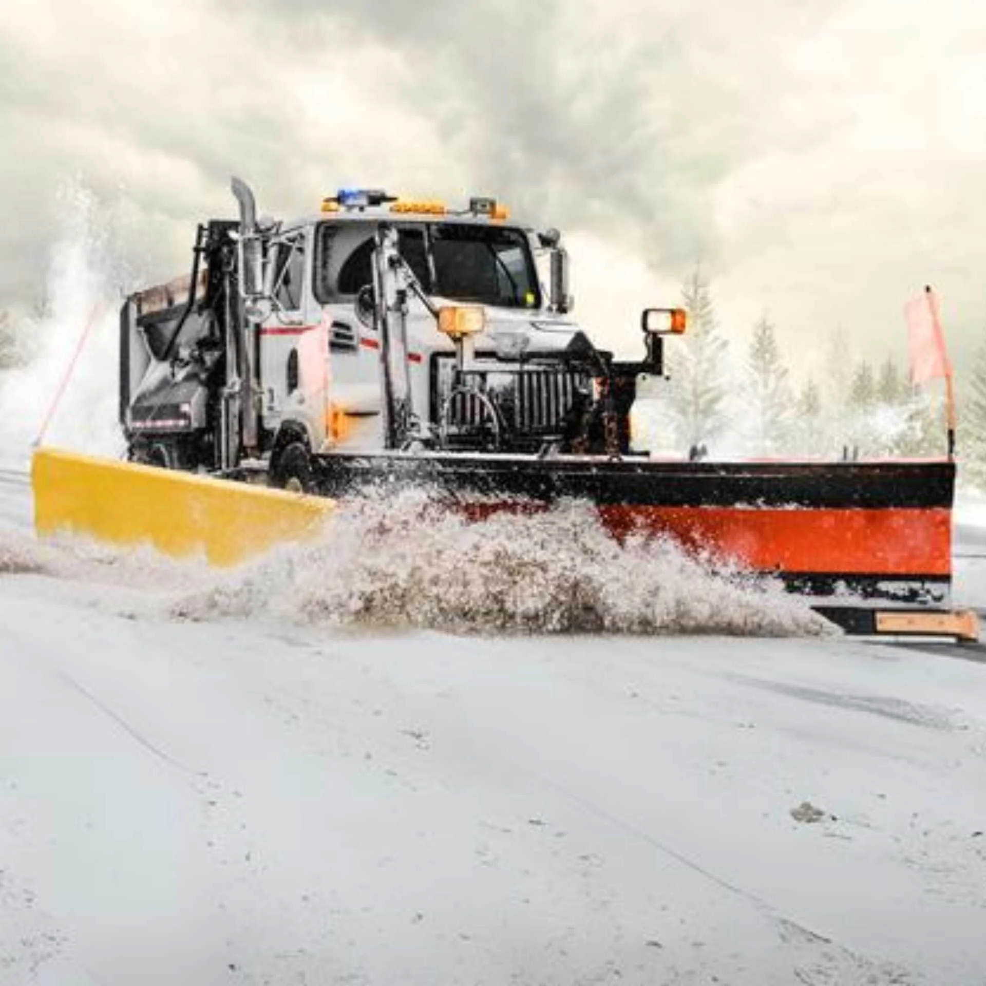 A snow plow clears a snowy road, ensuring safe passage through the winter landscape.